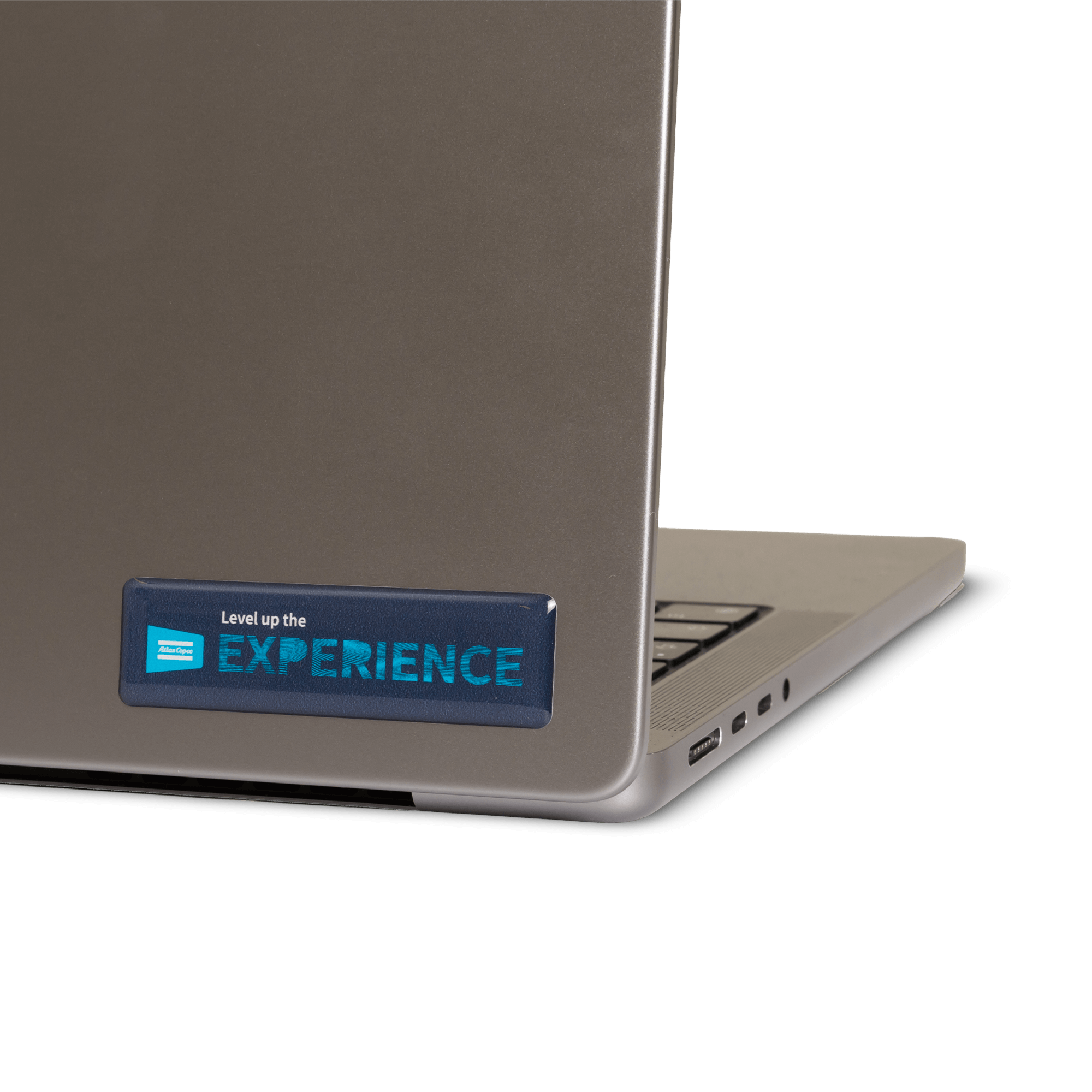 Atlas copco stickers with level up the experience text and graphics on laptop